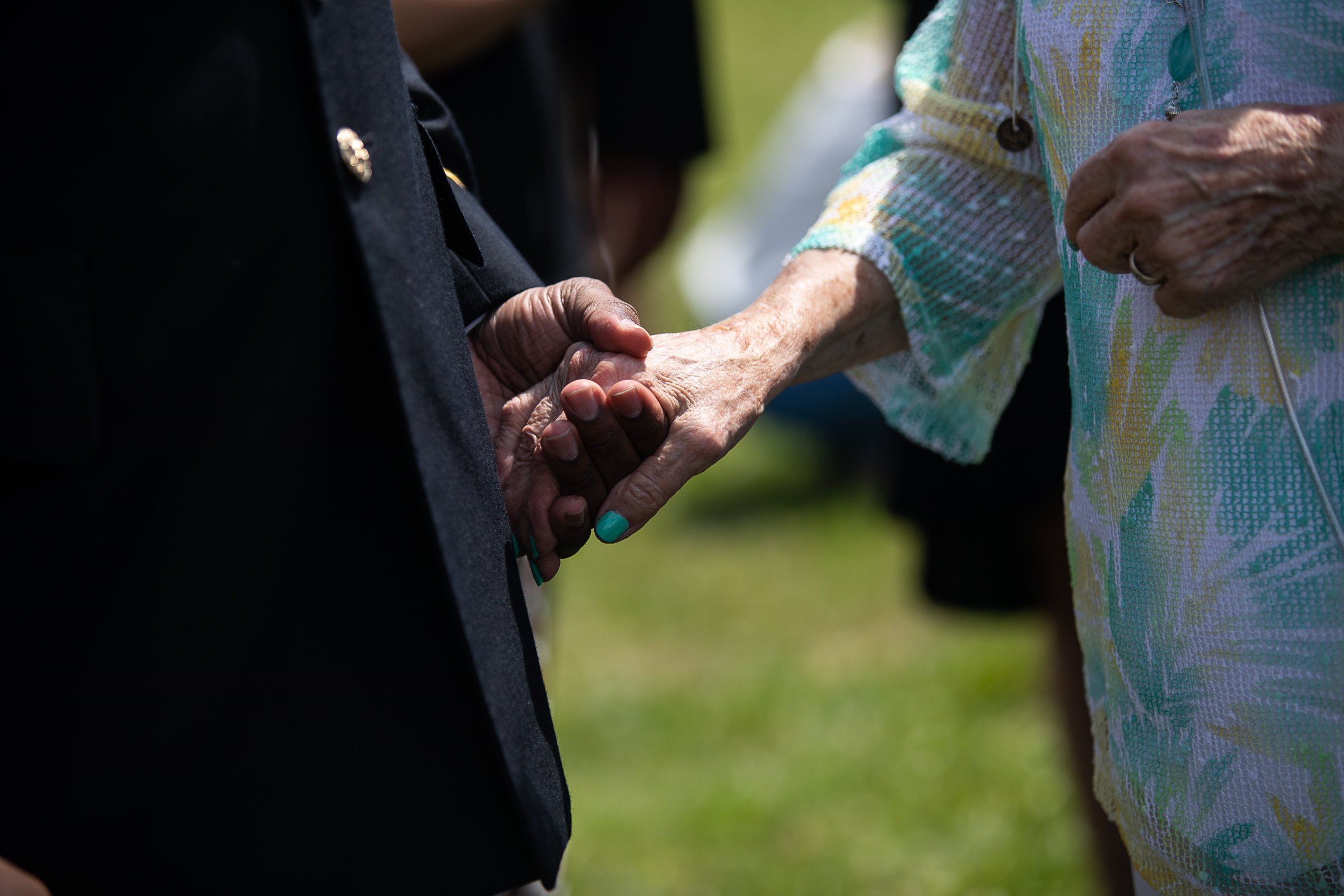 Staff photo by Troy Stolt / Sgt. First Class Kentrate Wedge holds the hand of Evelyn Snyder, the sister of the late Army Cpl. Henry L. Helms, as Snyder thanks him for helping her through her brother's funeral on Saturday, May 22, 2021 in Ringgold, Georgia. Helms, who was ruled missing in action for seven decades, was identified by his family and given full honors with funeral rites after a 2018 meeting between North Korean Chairman Kim Jong Un and former President Donald Trump, in which an agreement was struck to repatriate remains of Americans collected from the Korean War.