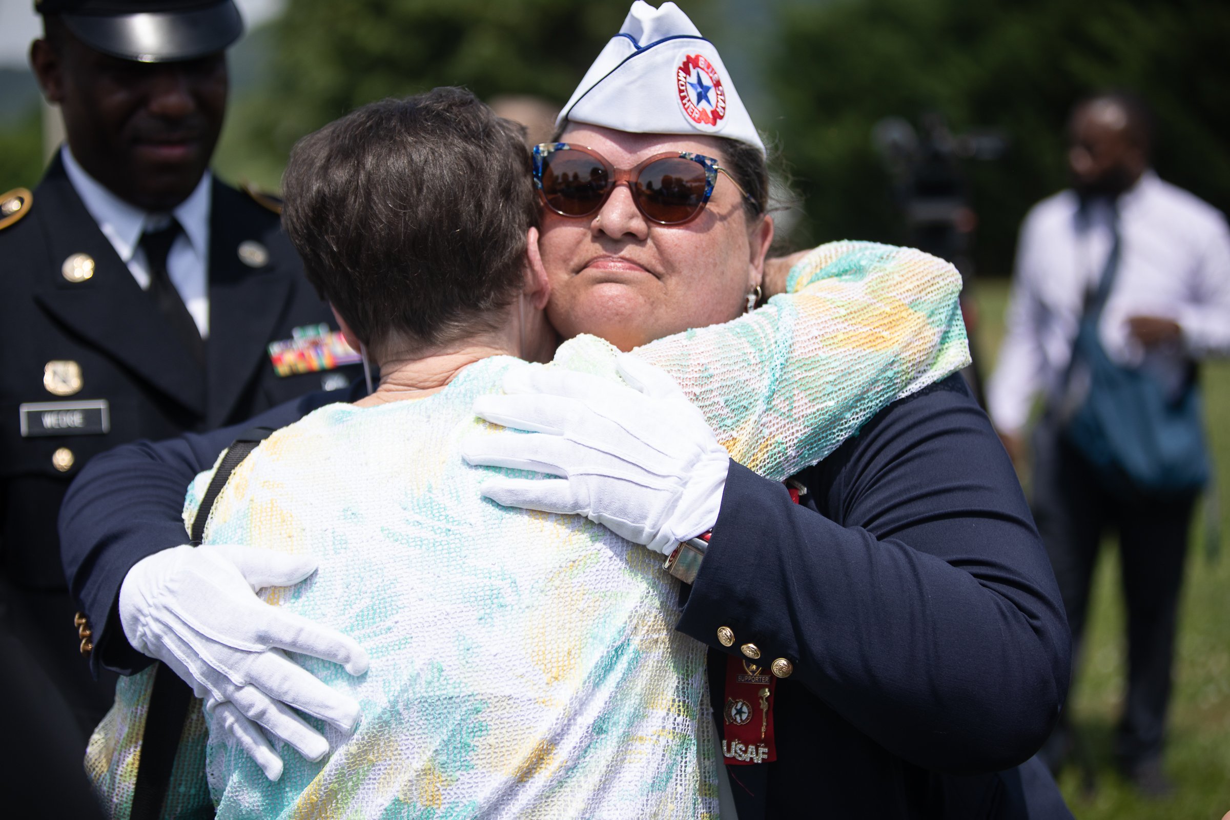 Staff photo by Troy Stolt / Evelyn Snyder, sister of the late Army Cpl. Henry Helms is embraced by Coni Brooks after a funeral for her brother at Anderson Memorial Gardens on Saturday, May 22, 2021 in Ringgold, Georgia. Helms, who was ruled missing in action for seven decades, was identified by his family and given full honors with funeral rites after a 2018 meeting between North Korean Chairman Kim Jong Un and former President Donald Trump, in which an agreement was struck to repatriate remains of Americans collected from the Korean War.