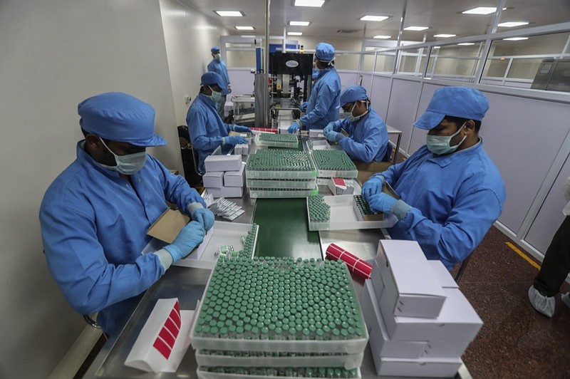FILE- In this Jan. 21, 2021, file photo, employees pack boxes containing vials of Covishield, a version of the AstraZeneca vaccine at the Serum Institute of India in Pune, India. (AP Photo/Rafiq Maqbool, File)



