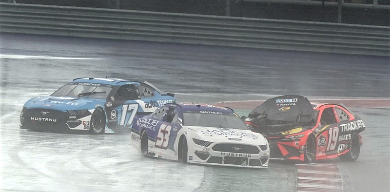 AP photo by Chuck Burton / Martin Truex Jr., right, slides through the 12th turn at the Circuit of the Americas after a crash as Chris Buescher, left, and Garrett Smithley drive around him during Sunday's NASCAR Cup Series race at the road course in Austin, Texas.