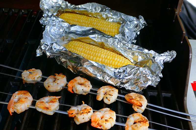 Photo by Linda Gassenheimer/TNS / The corn on the cob needs to go on the grill first, for about 10 minutes. The shrimp will be done in about four minutes.