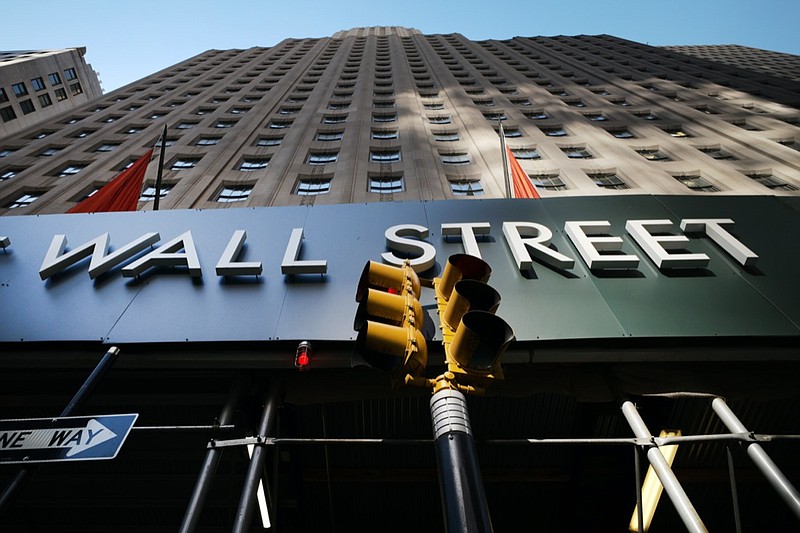 A sign for a Wall Street building is shown, Wednesday, May 19, 2021 in New York. Stocks are opening broadly higher on Wall Street, starting the week on a positive note following two straight weeks of losses for most major indexes. The S&P 500 was up 0.6% in the early going Monday, May 24. (AP Photo/Mark Lennihan)

