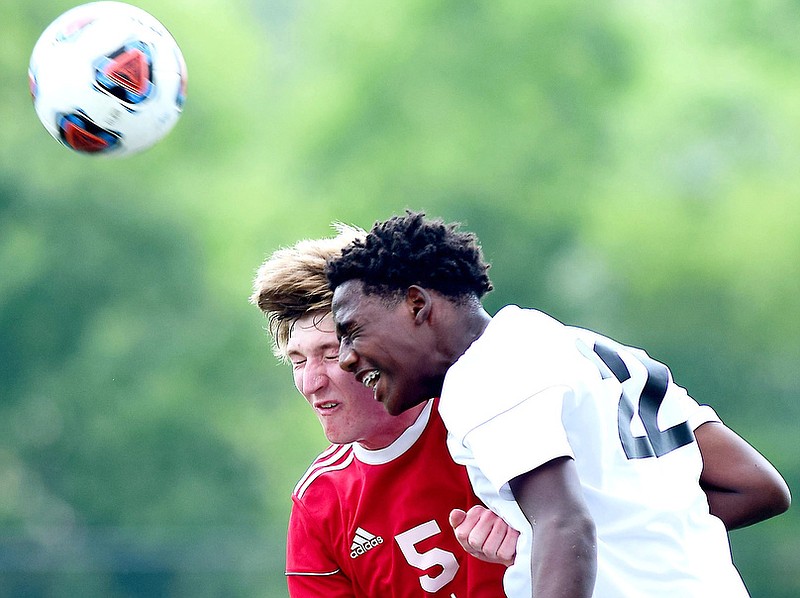 Staff Photo by Robin Rudd / Signal Mountain's Benjamin Burns (5) goes up for a header against Madison Magnet's Mekhi Morris (22) in TSSAA Spring Fling action in Murfreesboro on May 25, 2021. 