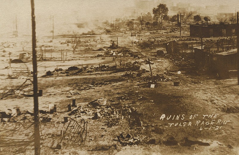 This photo provided by the Department of Special Collections, McFarlin Library, The University of Tulsa shows the ruins of Dunbar Elementary School and the Masonic Hall in the aftermath of the June 1, 1921, Tulsa Race Massacre in Tulsa, Okla. (Department of Special Collections, McFarlin Library, The University of Tulsa via AP)