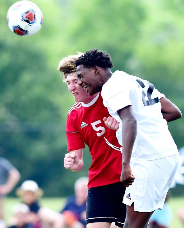 Staff Photo by Robin Rudd / Signal Mountain's Benjamin Burns (5) goes up for a header against Madison Magnet's Mekhi Morris (22) in TSSAA Spring Fling action in Murfreesboro on May 25, 2021.