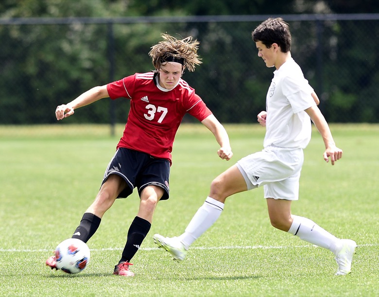 Staff Photo by Robin Rudd / Signal Mountain's Pete Sesterhenn (37) works the ball against a Madison Magnet defender in TSSAA Spring Fling action at the Sigel Soccer Complex in Murfreesboro on May 25, 2021.