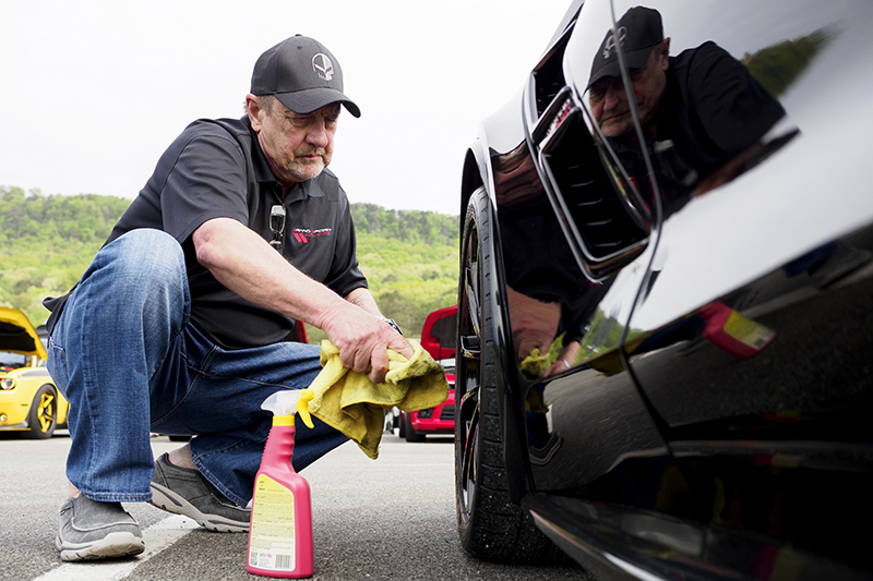 Staff photo by C.B. Schmelter / Mark Davey cleans the wheels of his 2019 Corvette.