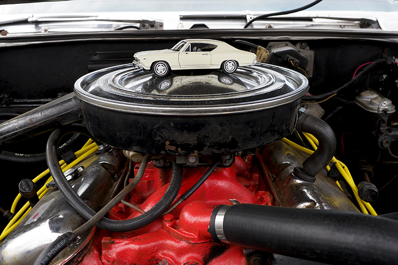 Staff photo by C.B. Schmelter / A model sits on the engine of a 1968 Chevelle SS.