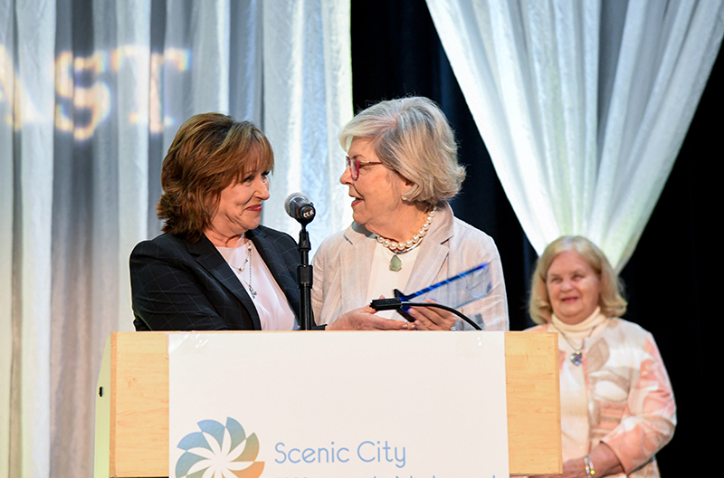 Photo by Mark Gilliland / 2021 Lydia Impact Award honoree Jan Silvious, center, receives the award from Cindy Sexton.