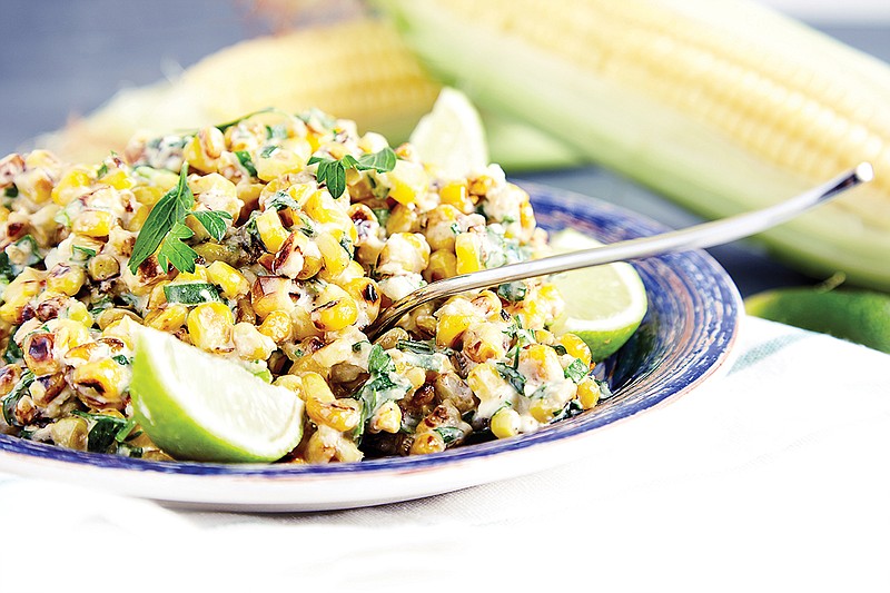 Getty Images / Homemade Mexican street corn salad is seen with avocado and lime.