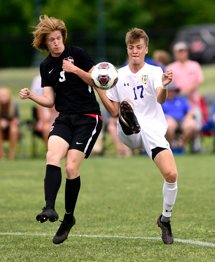 Staff Photo by Robin Rudd / Boyd-Buchanan's Tyson Campbell (17) gets to the ball before Franklin Grace's Bryant Euban (3). Boyd-Buchanan faced Franklin Grace at the Sigel Soccer Complex in Murfreesboro on May 26, 2021.