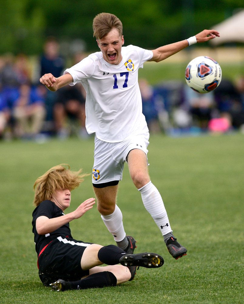 Staff Photo by Robin Rudd / Franklin Grace's Bryant Eubank (3) uses a sliding tackle to knock the ball from Boyd-Buchanan's Tyson Campbell (17). Boyd-Buchanan faced Franklin Grace at the Sigel Soccer Complex in Murfreesboro on May 26, 2021.