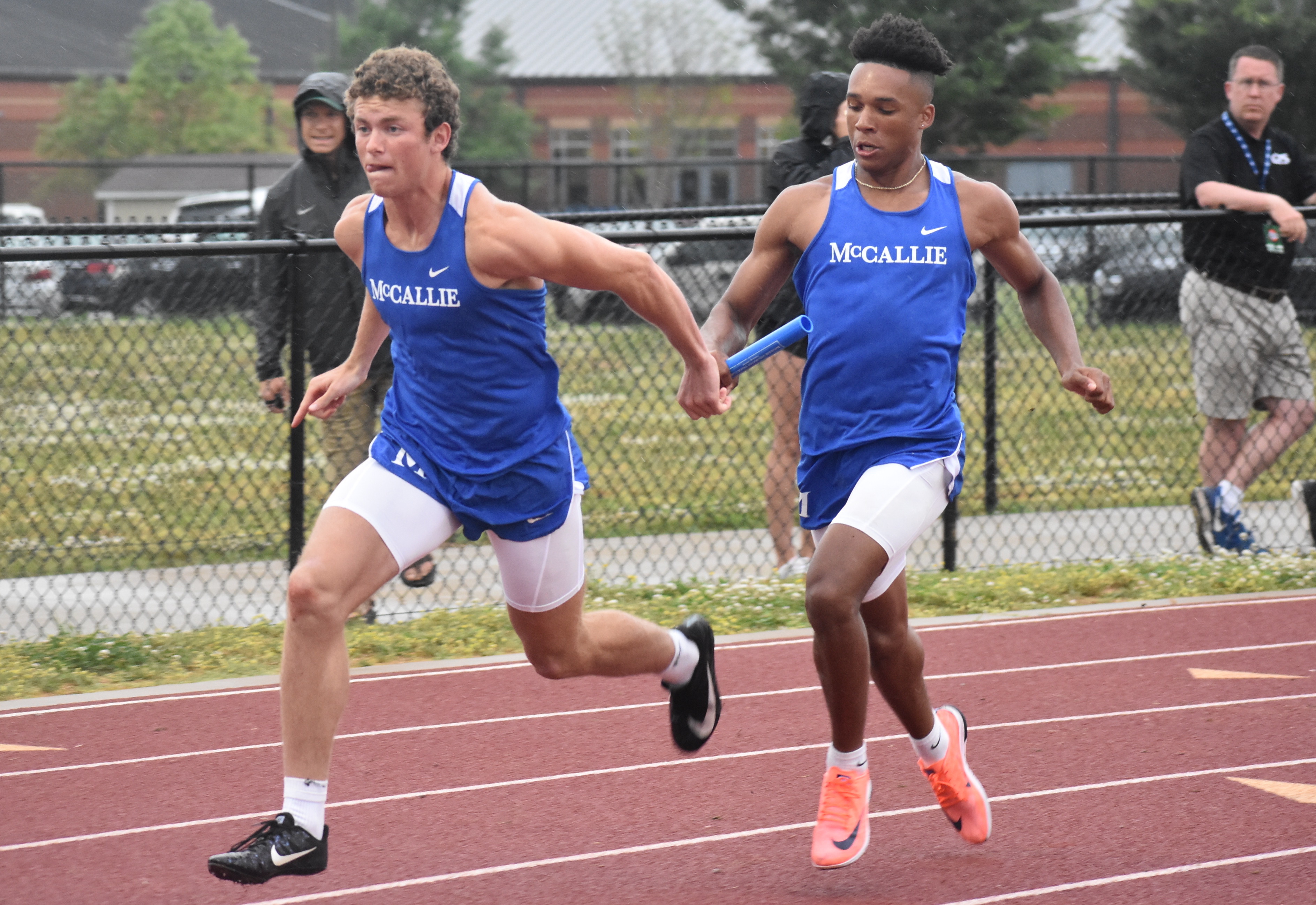 Staff photo by Patrick MacCoon / McCallie's John Kohl, left, takes the baton from Eric Rivers as the Blue Tornado race to the 4x100 relay state title at the TSSAA Division II-AA meet Wednesday in Murfreesboro.