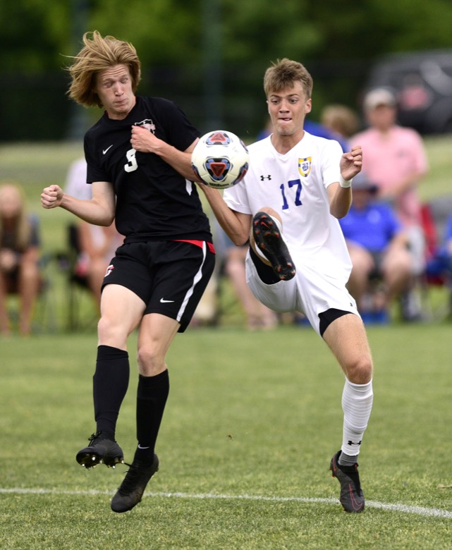Staff Photo by Robin Rudd / Boyd-Buchanan's Tyson Campbell (17) gets to the ball before Franklin Grace's Bryant Euban (3). Boyd-Buchanan faced Franklin Grace at the Sigel Soccer Complex in Murfreesboro on May 26, 2021.