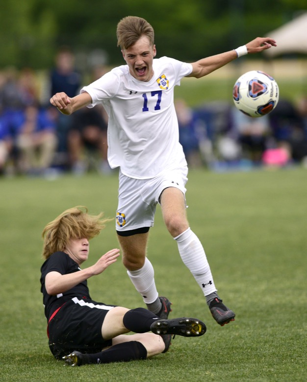 Staff Photo by Robin Rudd / Franklin Grace's Bryant Eubank (3) uses a sliding tackle to knock the ball from Boyd-Buchanan's Tyson Campbell (17). Boyd-Buchanan faced Franklin Grace at the Sigel Soccer Complex in Murfreesboro on May 26, 2021.