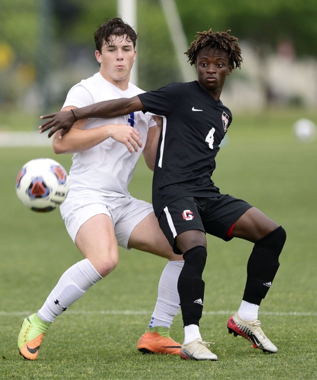 Staff Photo by Robin Rudd / Boyd-Buchanan's Matt Stone (3) and Franklin Grace's Levi Jones (4) fight for the ball. Boyd-Buchanan faced Franklin Grace at the Sigel Soccer Complex in Murfreesboro on May 26, 2021.