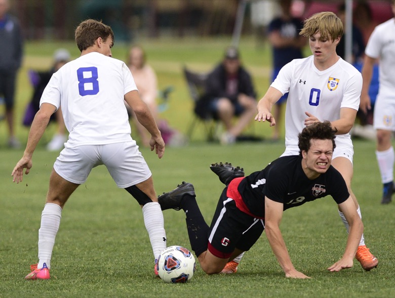 Staff Photo by Robin Rudd / A Franklin Grace player goes down between Boyd-Buchanan's Cam Park (8) and Jake Logan (0). Boyd-Buchanan faced Franklin Grace at the Sigel Soccer Complex in Murfreesboro on May 26, 2021.