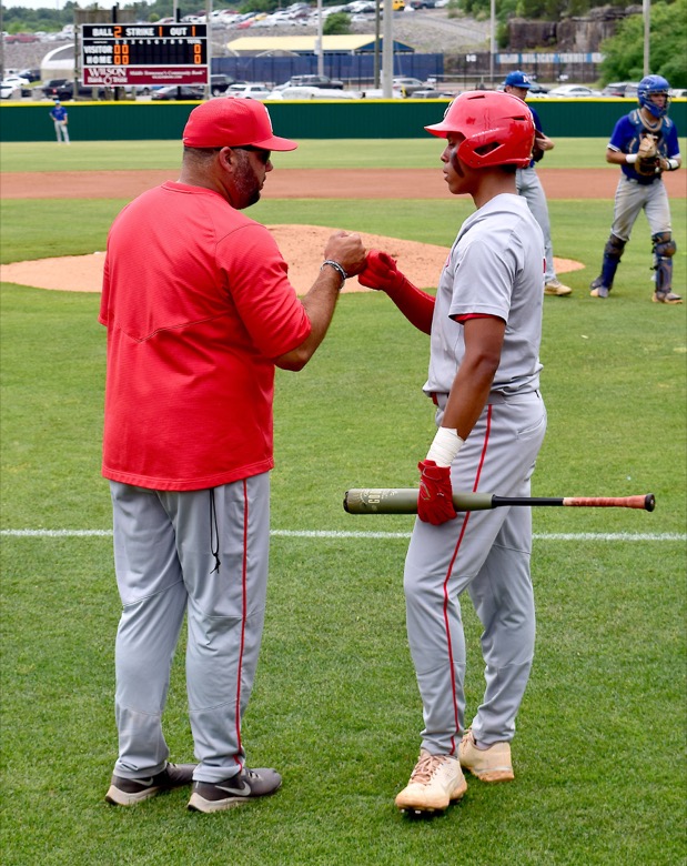 Staff Photo by Robin Rudd / Baylor co head coach Greg Elie fist pumps with Daniel Corona (3) during a timeout. Baylor faced McCalliein TSSAA Spring Fling baseball at Wilson Central High School in Galdeville on May 26, 2021.