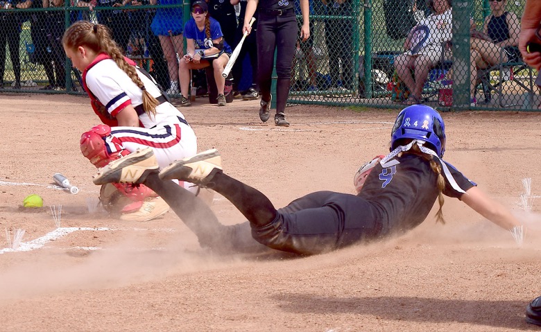 Staff Photo by Robin Rudd / GPS's Chapel Cunningham (9) scores at home as the St. Benedict catcher takes the throw. GPS faced St. Benedict in TSSAA Spring Fling softball at the the Starplex in Murfreesboro on May 26, 2021.