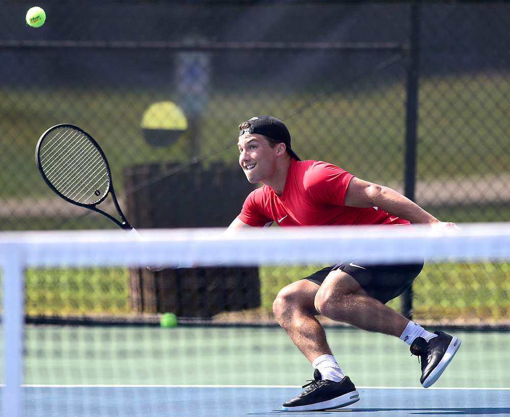 Staff Photo by Robin Rudd / Collegedale Academy's Joby Nash jumps goes low for a return to Lusanne's Danny Hamze during TSSAA Spring Fling tennis at the Adams Tennis Complex in Murfreesboro on May 27, 2021.
