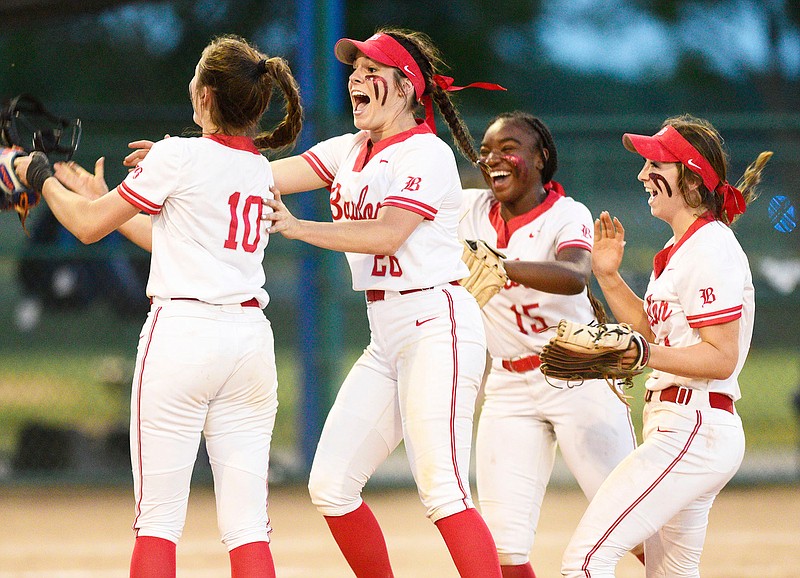 Staff photo by Robin Rudd / Baylor pitcher Acelynn Sellers (10) is mobbed by Raven Jones (26), Cadashia Collins (15) and Morgan Sharpe as the Lady Red Raiders celebrate beating GPS to win their sixth straight softball state title Thursday night in Murfreesboro, Tenn.