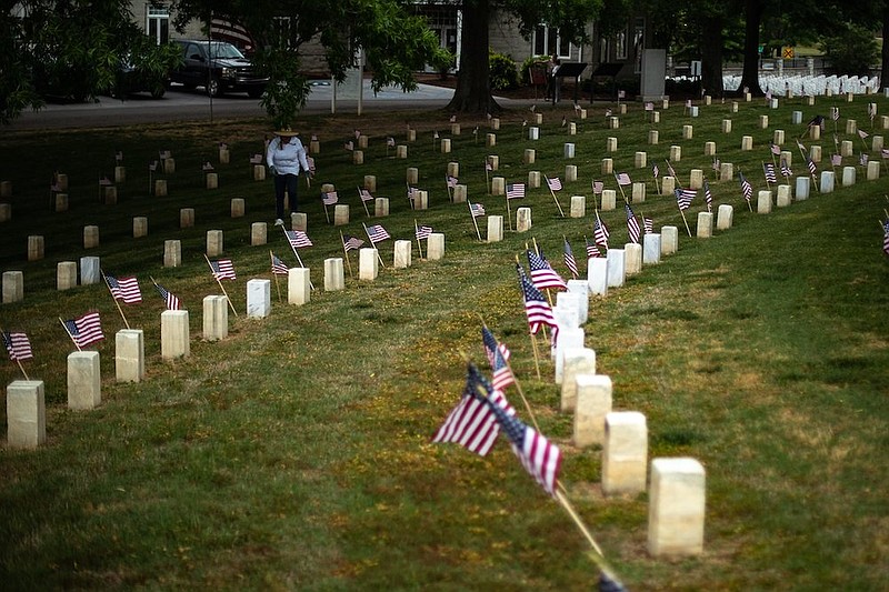 Staff photo by Troy Stolt / Flags laid down by local Boy Scout troops are seen at the National Cemetery on Friday, May 28, 2021 in Chattanooga, Tenn.