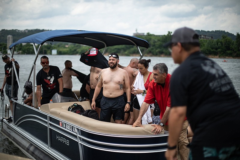 Staff photo by Troy Stolt / Participants of the Shepherd's Men swim from the Fallen Five Memorial at the Tennessee River Park to Ross's landing wait to touch ground after getting onto their support boat on Friday, May 28, 2021 in Chattanooga, Tenn.
