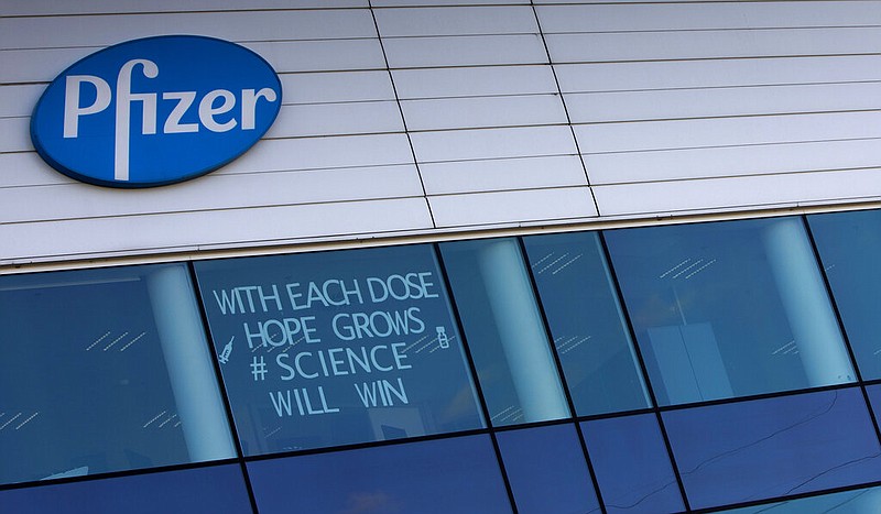 In this Tuesday, Feb. 23, 2021 file photo, a sign is pasted into an upper window at Pfizer manufacturing center in Puurs, Belgium. The European Union cemented its support for Pfizer-BioNTech and its novel COVID-19 vaccine technology, Saturday, May 8, 2021 by agreeing to a massive contract extension for a potential 1.8 billion doses through 2023. The new contract, which has the backing of the EU member states, will entail not only the production of the vaccines, but also making sure that all the essential components should be sourced from the EU. (AP Photo/Virginia Mayo, File)
