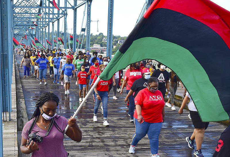Staff Photo by Robin Rudd / Flag-bearers and attendees move to south side of the Walnut Street Bridge for the ceremony.  