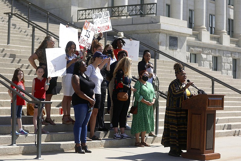 In this May 19, 2021, file photo, Betty Sawyer joins educators and community activists in protesting Utah lawmakers' plans to pass resolutions encouraging a ban of critical race theory concepts outside of the Capitol in Salt Lake City as both supporters and counterprotesters stand behind her. (Kristin Murphy/The Deseret News via AP)