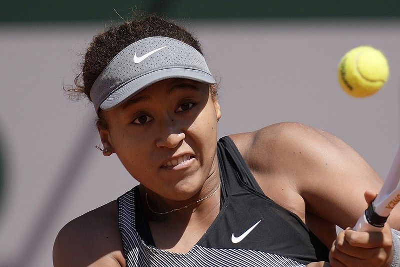 FILE - Japan's Naomi Osaka returns the ball to Romania's Patricia Maria Tig during their first round match of the French open tennis tournament at the Roland Garros stadium in Paris, in this Sunday, May 30, 2021, file photo. Naomi Osaka withdrew from the French Open on Monday, May 31, and wrote on Twitter that she would be taking a break from competition, a dramatic turn of events for a four-time Grand Slam champion who said she has "suffered long bouts of depression."(AP Photo/Christophe Ena, File)