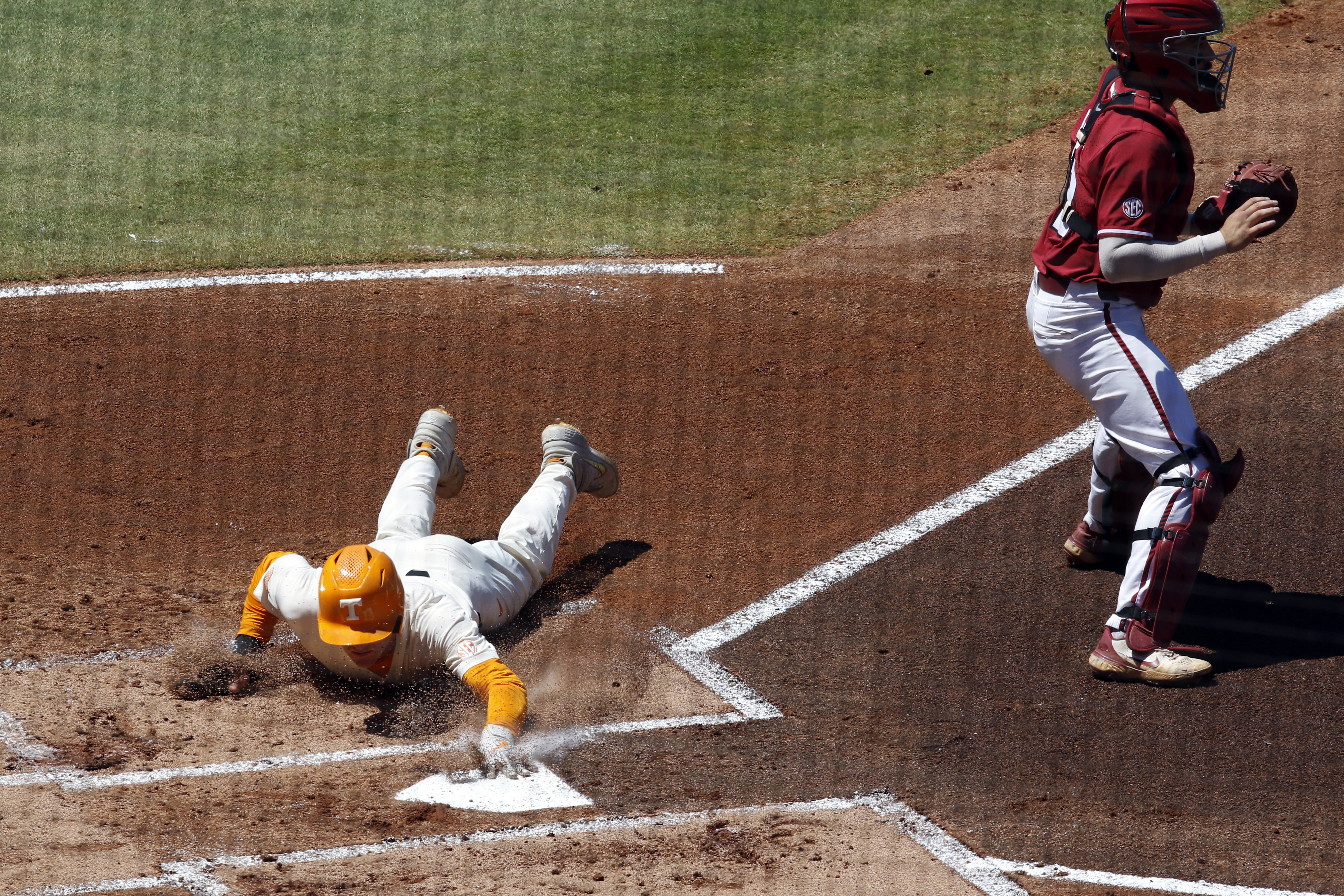 AP photo/Butch Dill / Tennessee's Jake Rucker slides safely into home plate during the first inning of Sunday afternoon's Southeastern Conference championship game between the Volunteers and Arkansas. The Razorbacks would pull away late for a 7-2 win.
