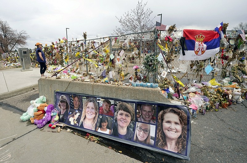 FILE - In this Friday, April 23, 2021, file photo, photographs of the 10 victims of a mass shooting in a King Soopers grocery store are posted on a cement barrier outside the supermarket in Boulder, Colo. (AP Photo/David Zalubowski, File)



