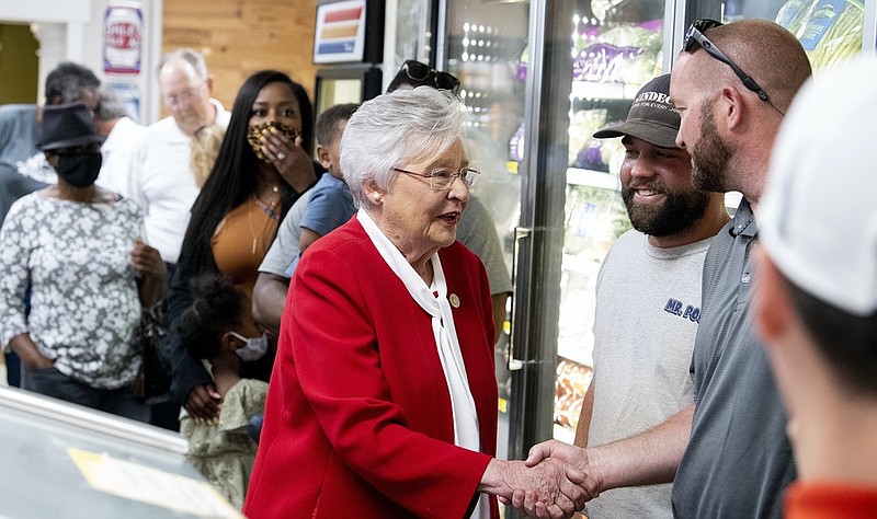 Alabama Governor Kay Ivey talks with customers at Filet & Vine in Montgomery, Ala., as she makes her first campaign stop on Wednesday, June 2, 2021. Ivey announced Wednesday that she's running for reelection, citing Alabama's "bucket load of common sense" in its response to the coronavirus pandemic. Ivey, 76, made the announcement in a video message released by her campaign. (Mickey Welsh/The Montgomery Advertiser via AP)