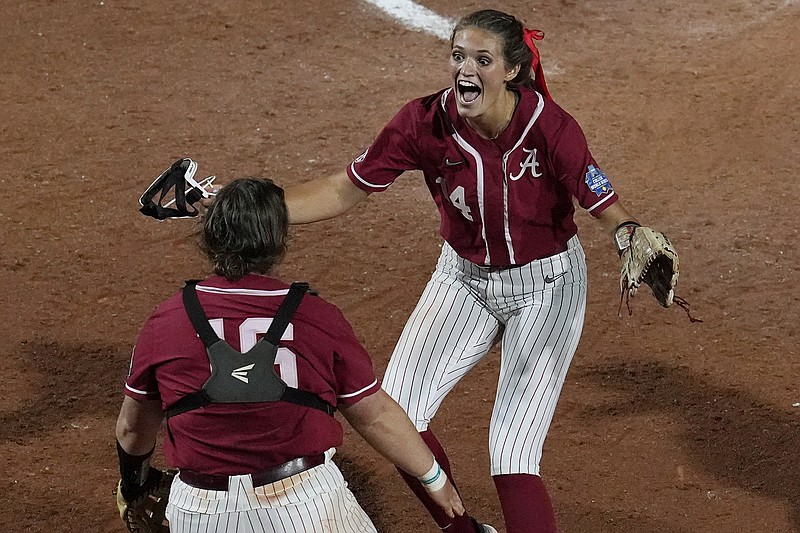 AP photo by Sue Ogrocki / Alabama pitcher Montana Fouts, right, celebrates her perfect game with catcher Bailey Hemphill after the Crimson Tide beat UCLA 6-0 on Friday night at the Women's College World Series.