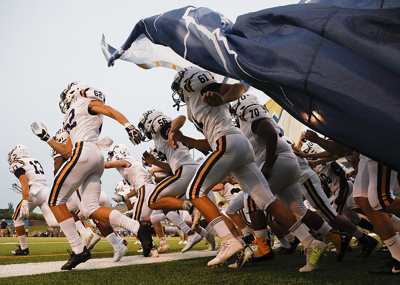 Staff photo by Troy Stolt / Chattanooga Christian football players run onto the field at Finley Stadium before a game against Boyd Buchanan last September.