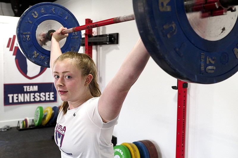 Staff photo by C.B. Schmelter / Notre Dame High School graduate Olivia Reeves lifts weights Saturday at Tennessee Speed and Strength in Chattanooga. Reeves recently won two gold medals and a silver at the International Federation Junior World Champioships in Uzbekistan, and she hopes to represent the United States in weightlifting at the 2024 Olympics in Paris.