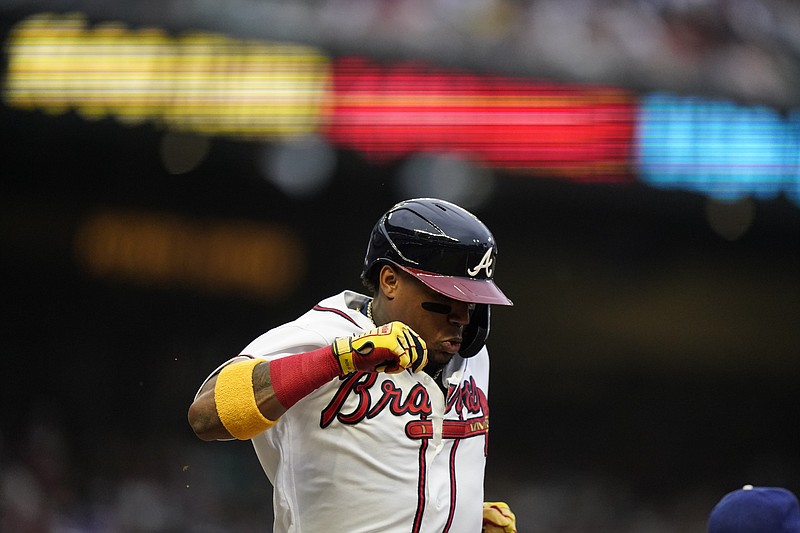 AP photo by Brynn Anderson / The Atlanta Braves' Ronald Acuña Jr. runs to first base after making contact in the first inning of Saturday's home game against the Los Angeles Dodgers.
