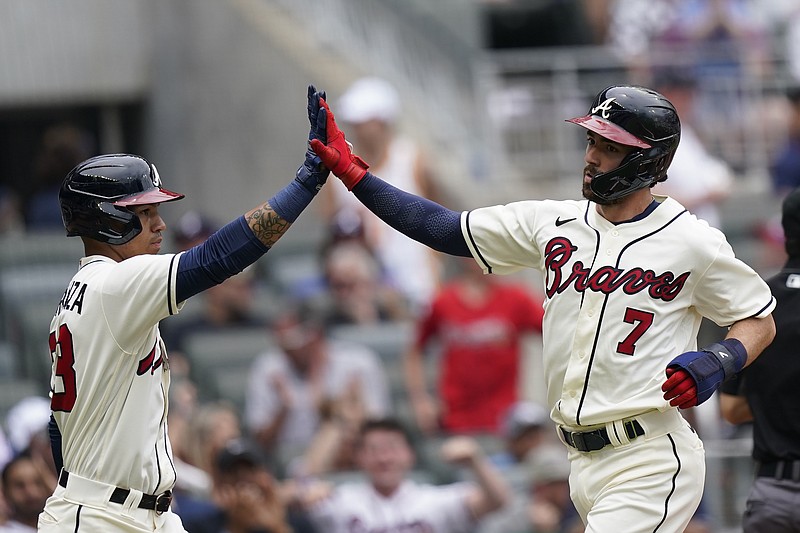 AP photo by Brynn Anderson / Atlanta Braves shortstop Dansby Swanson, right, celebrates with Ehire Adrianza after scoring in the second inning of Sunday's home game against the Los Angeles Dodgers.