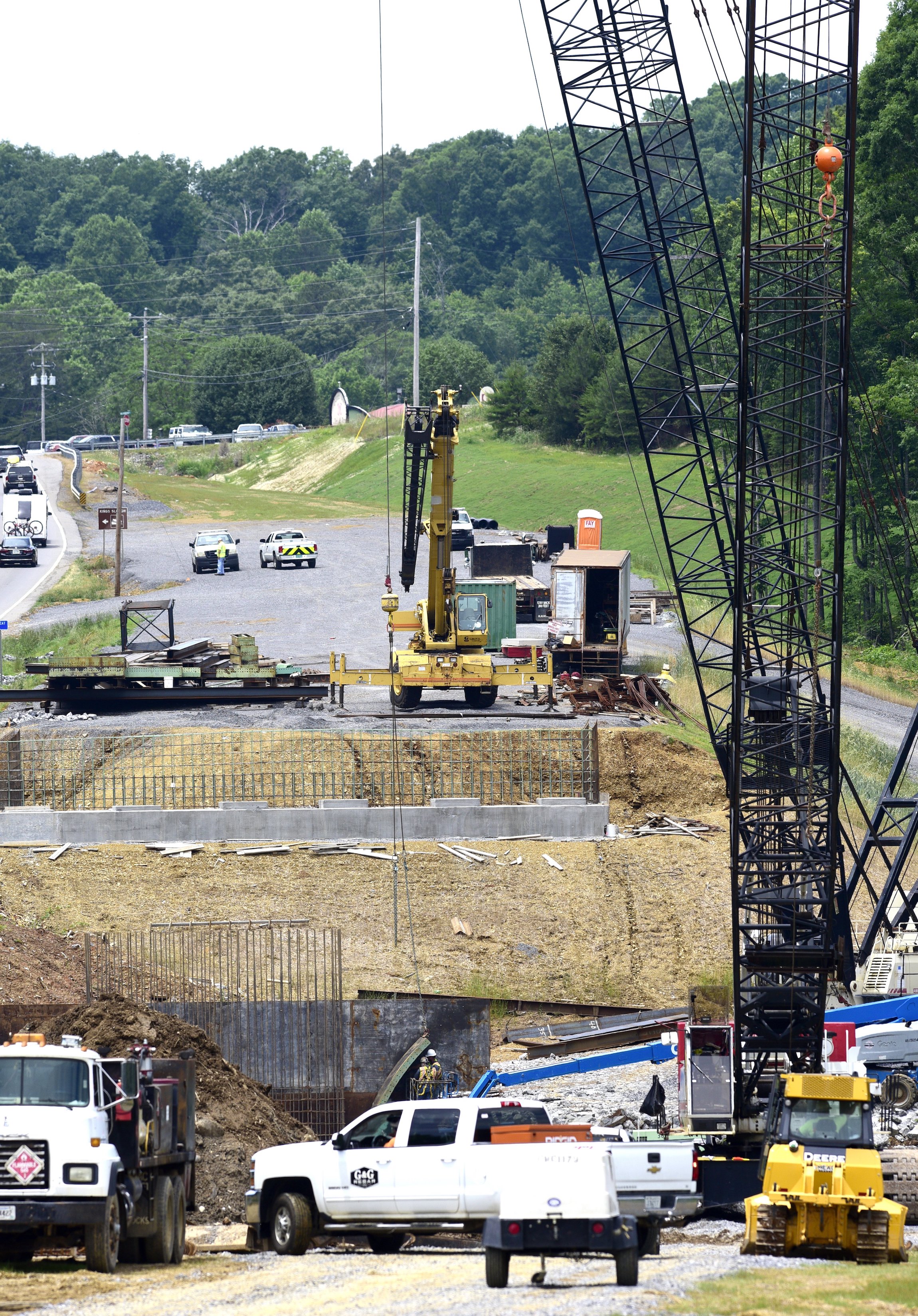 Staff Photo by Robin Rudd / Contractor Charles Blalock and Sons, Inc. contiunes on the State Route-40 (US-64) bridge over the Ocoee River on June 4, 2021. The contractor is working on foundations for the new bridge and relocation of utilities Brief intermittent lane closures are possible Monday through Friday 8 AM to 5:30 PM to allow for utility work and moving equipment/supplies.