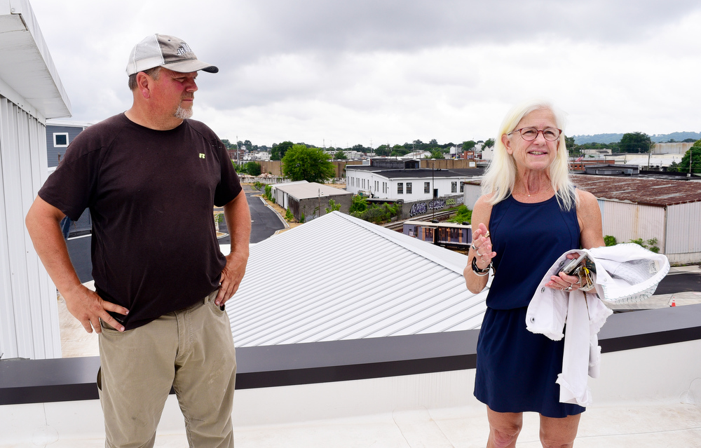 Staff Photo by Robin Rudd / From left, Mike Croxall, owner of Croxall Construction Co., and Dede Engsberg talk about the renovation of the Burnside. Partners Dede and Towson Engsberg, of SEI Ventures of Tennessee, LLC have teamed with Nathan and Doug Kirkman of DNK Development, LLC to renovate the former Acme Box Company as the Burnside. The Burnside, located at 2100 Rossville Avenue will feature apartments, a restaurant, offices, and retail spaces.