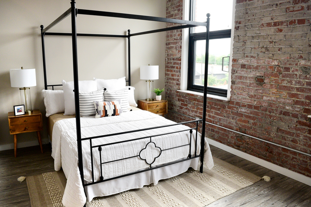 Staff Photo by Robin Rudd / The original brick walls is a feature of this bedroom at the Burnside. Partners Dede and Towson Engsberg, of SEI Ventures of Tennessee, LLC have teamed with Nathan and Doug Kirkman of DNK Development, LLC to renovate the former Acme Box Company as the Burnside. The Burnside, located at 2100 Rossville Avenue will feature apartments, a restaurant, offices, and retail spaces.