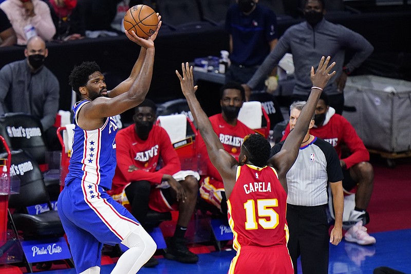 AP photo by Matt Slocum / The Philadelphia 76ers' Joel Embiid shoots over the Atlanta Hawks' Clint Capela during Game 2 of their Eastern Conference semifinal series Tuesday night in Philadelphia.