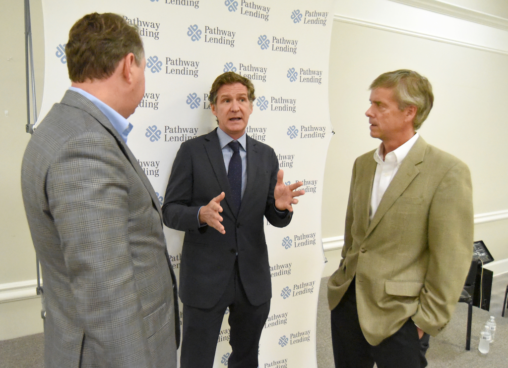 Staff Photo by Matt Hamilton / Chattanooga mayor Tim Kelly, middle, speaks with Pathway Lending president Clint Gwin, left, and Charlie Brock during an event at the Urban League Office on Wednesday, June 9, 2021.