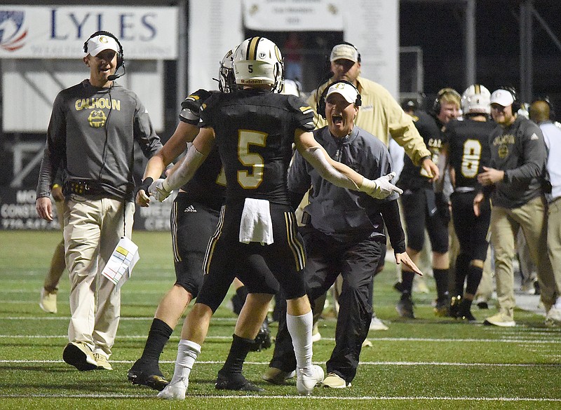 Staff photo by Matt Hamilton / Calhoun assistant coach Justin Bishop celebrates with receiver Cole Speer (5) after he scored a touchdown during a GHSA playoff game in December 2020.