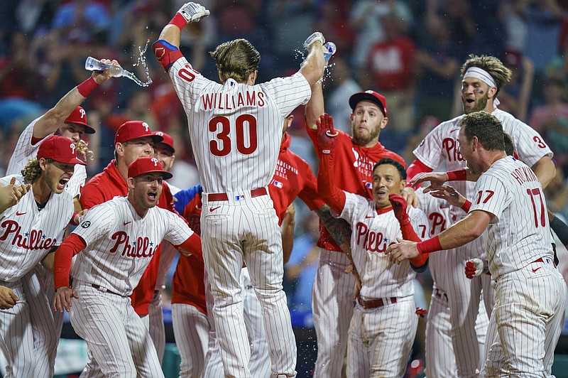 AP photo by Chris Szagola / Philadelphia Phillies rookie Luke Williams is welcomed by his teammates after hitting a two-run homer to beat the visiting Atlanta Braves 2-1 on Wednesday night.