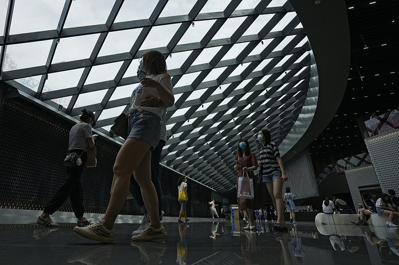 People wearing face masks to help curb the spread of the coronavirus visit a shopping mall in Beijing, Sunday, June 6, 2021. (AP Photo/Andy Wong)


