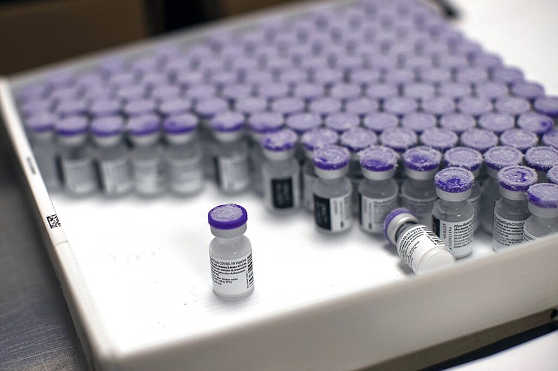 In this Monday, Jan. 4, 2021 file photo, frozen vials of the Pfizer/BioNTech COVID-19 vaccine are taken out to thaw, at the MontLegia CHC hospital in Liege, Belgium. The U.S. will buy 500 million more doses of the Pfizer COVID-19 vaccine to share through the COVAX alliance for donation to 92 lower income countries and the African Union over the next year, a person familiar with the matter said Wednesday. President Joe Biden was set to make the announcement Thursday in a speech before the start of Group of Seven summit. (AP Photo/Francisco Seco, File)