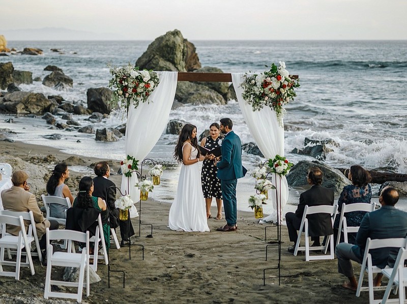 This photo shows bride Namisha Balagopal and groom Suhaas Prasad getting married in a small legal ceremony Aug. 15, 2020, on Muir Beach near San Francisco. (Vellora Productions via AP)


