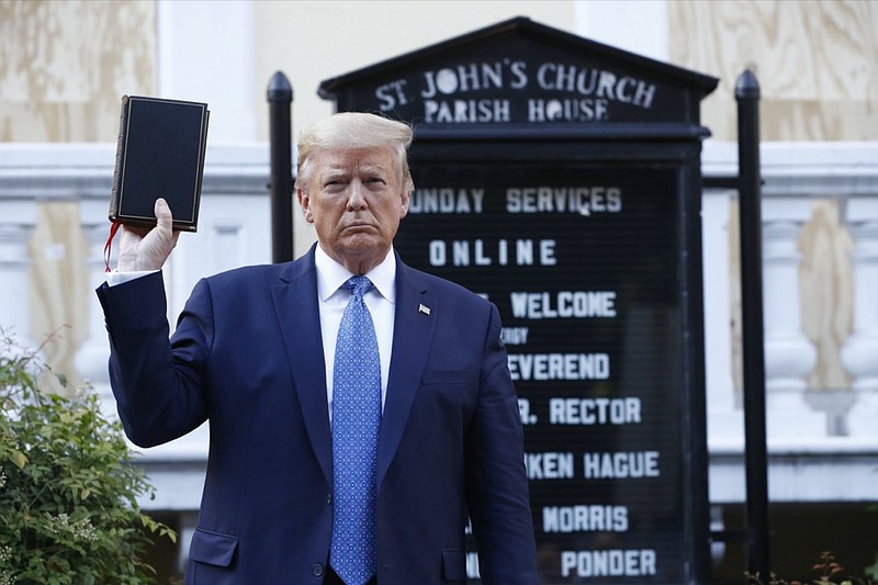 FILE - In this June 1, 2020, file photo President Donald Trump holds a Bible as he visits outside St. John's Church across Lafayette Park from the White House in Washington. An internal investigation has determined that the decision to clear racial justice protestors from an area in front of the White House last summer was not influenced by then-President Donald Trump's plans for a photo opportunity at that spot. The report released Wednesday by the Department of Interior's Inspector General concludes that the protestors were cleared by U.S. Park Police on June 1 of last year so new fencing could be installed. (AP Photo/Patrick Semansky, File)


